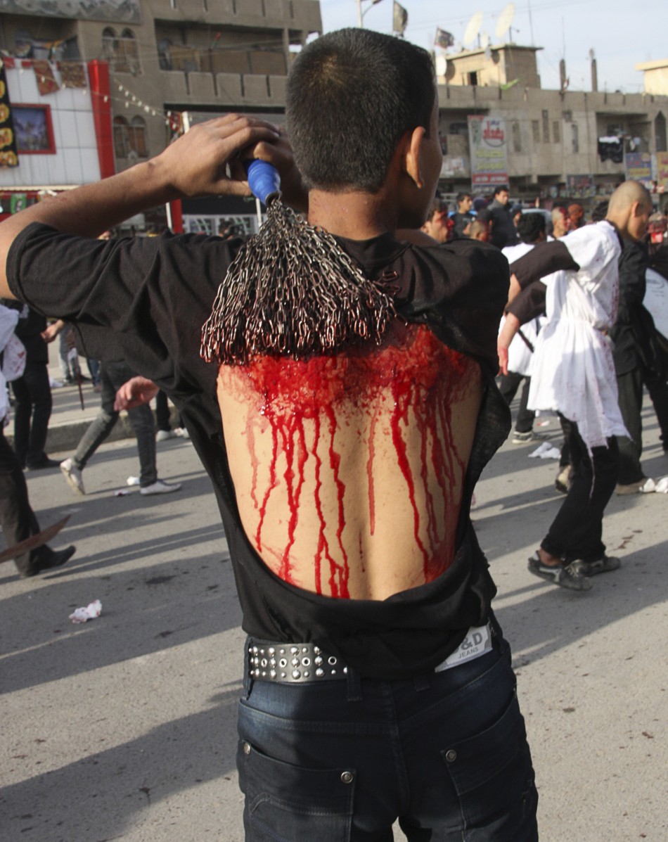 A Shiite man flagellates himself during a ceremony marking the Ashura procession in Baghdads Sadr City