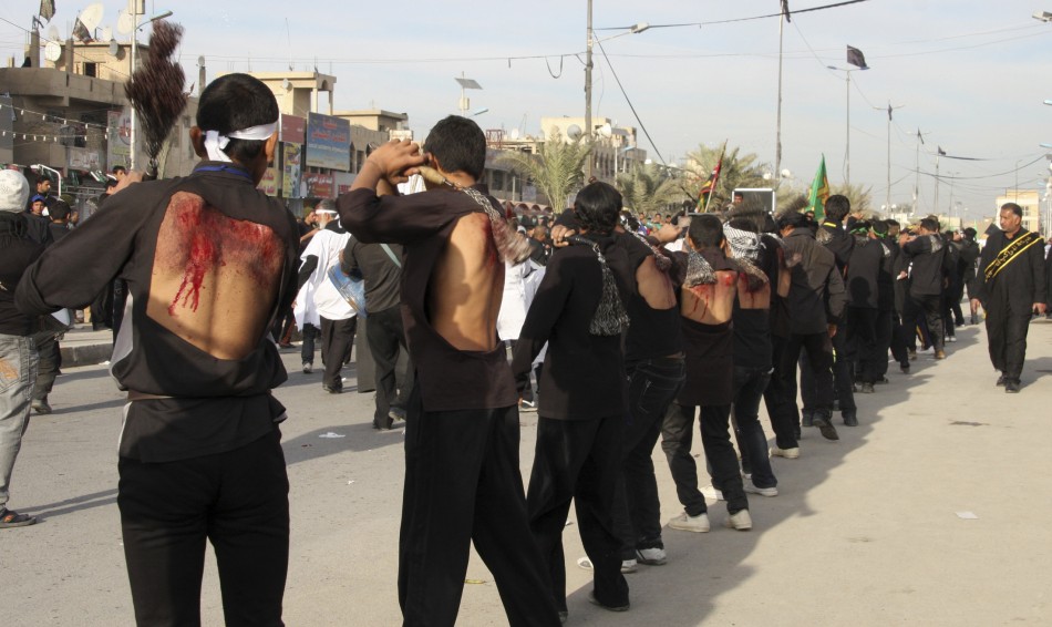 Shiite men flagellate themeselves during a ceremony marking the Ashura procession in Baghdads Sadr City