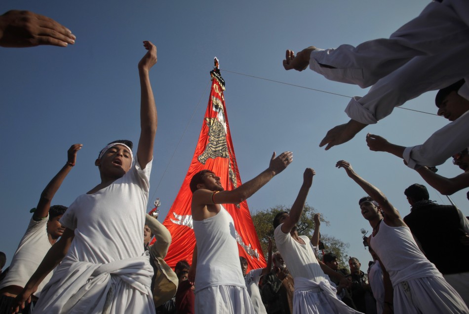 Shiite Muslims beat their chests as they take part in a religious procession ahead of the Ashura festival in Islamabad