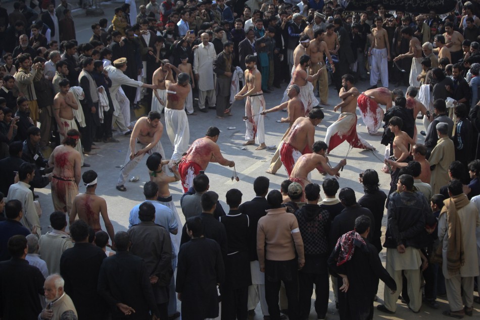Shiite Muslim men take part in self-flagellation during a religious procession ahead of the Ashura festival in Peshawar 05122011