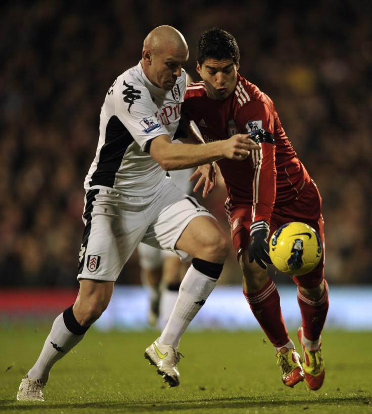Liverpool striker Luis Suarez (right), who has been charged by the Football Association over alleged racist remarks targeting Manchester United defender Patrice Evra in October, was seen making the obscene gesture — a one-fingered send-off — to the Fulham Liverpool striker Luis Suarez (right), who has been charged by the Football Association over alleged racist remarks targeting Manchester United defender Patrice Evra in October, was seen making the obscene gesture — a one-fingered send-off — to the Fulham