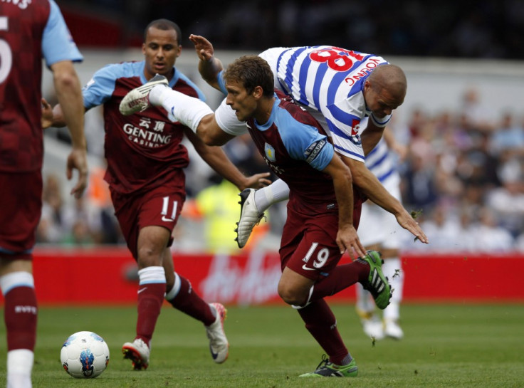 Queens Park Rangers' Luke Young (top) challenges Aston Villa's Stiliyan Petrov