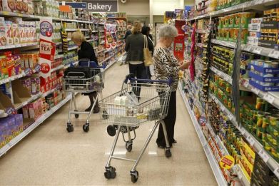 Customers shop for groceries in a supermarket in London