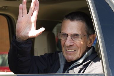 Actor Nimoy gives the &quot;Vulcan salute&quot; to the crowd while riding in a parade in the town of Vulcan