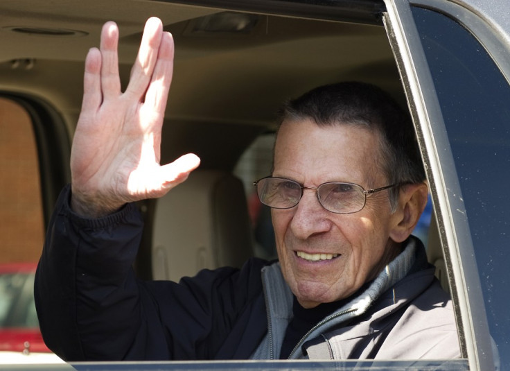 Actor Nimoy gives the &quot;Vulcan salute&quot; to the crowd while riding in a parade in the town of Vulcan