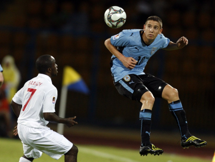 Ramirez of Uruguay jumps for a high ball in front of Brandy of England during their FIFA U-20 World Cup soccer match in Ismailia