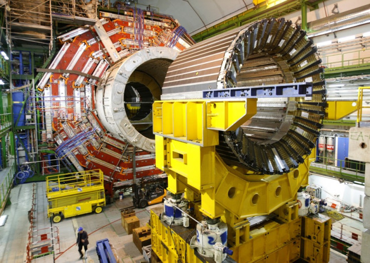A technician walks under the core magnet of the CMS experiment at the CERN in the village of Cessy