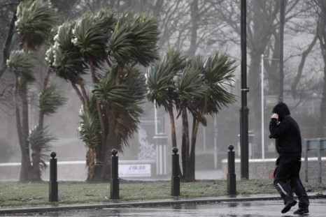 A man struggles against strong winds next to the promenade in Largs in west Scotland on Wednesday.
