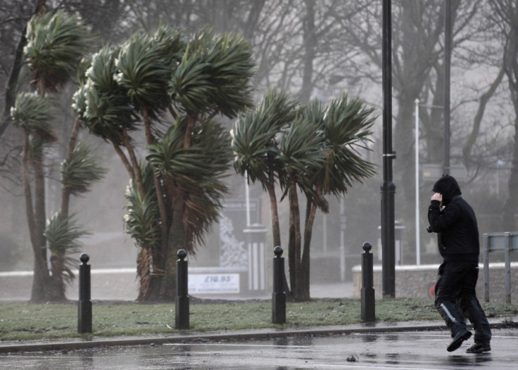 A man struggles against strong winds next to the promenade in Largs in west Scotland