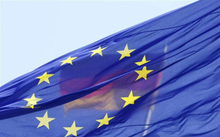 The German national flag is seen behind the EU flag up atop the Reichstag building, seat of the German lower house of parliament Bundestag in Berlin