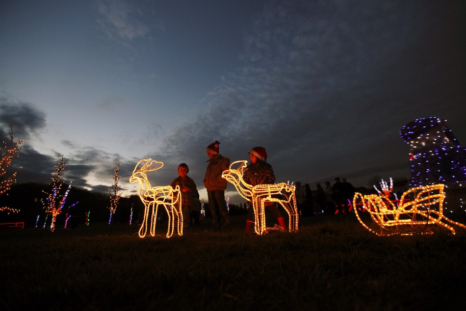 Children play with decorative raindeers at a country house estate in the village of Grabovnica near Cazma