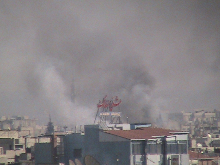Smoke rises from the city of Homs