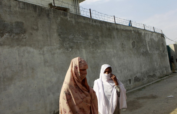 Residents stand outside the compound where al Qaeda leader Osama bin Laden was killed in Abbottabad