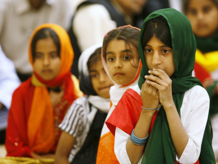 Children wait their turn to read the Koran with Head of Worldwide Ahmadiyya Muslim community Hadhrat Mirza Masroor Ahmad at the new Baitun Nur Mosque in Calgary