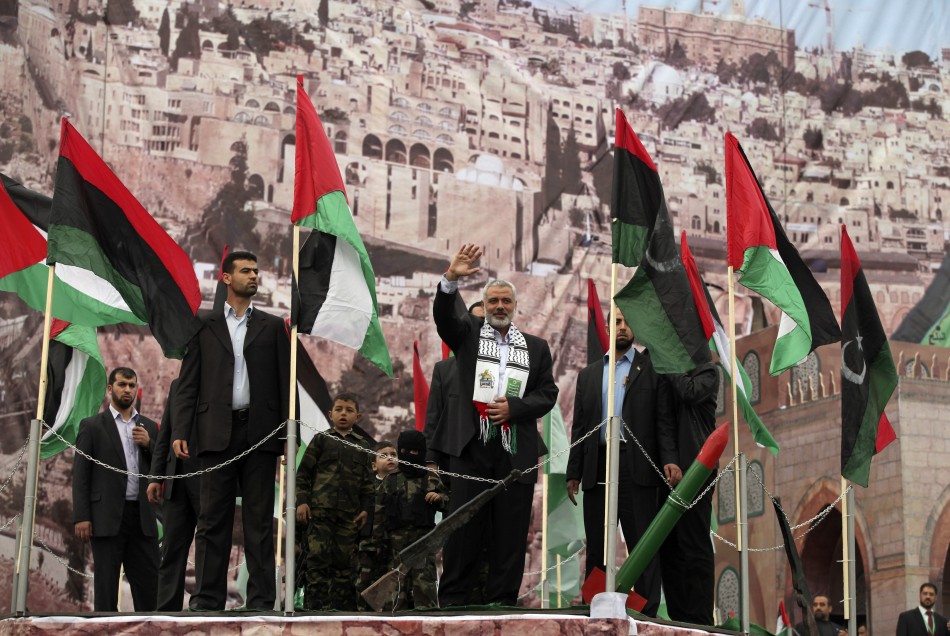 Senior Hamas leader Haniyeh waves upon his arrival at a rally in Gaza City
