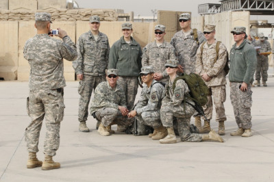 US military personnel pose for a picture before the start of a ceremony marking the end of the U.S. military engagement, at the former US Sather Air Base US military personnel pose for a picture before the start of a ceremony marking the end of the U.S. military engagement, at the former US Sather Air Base