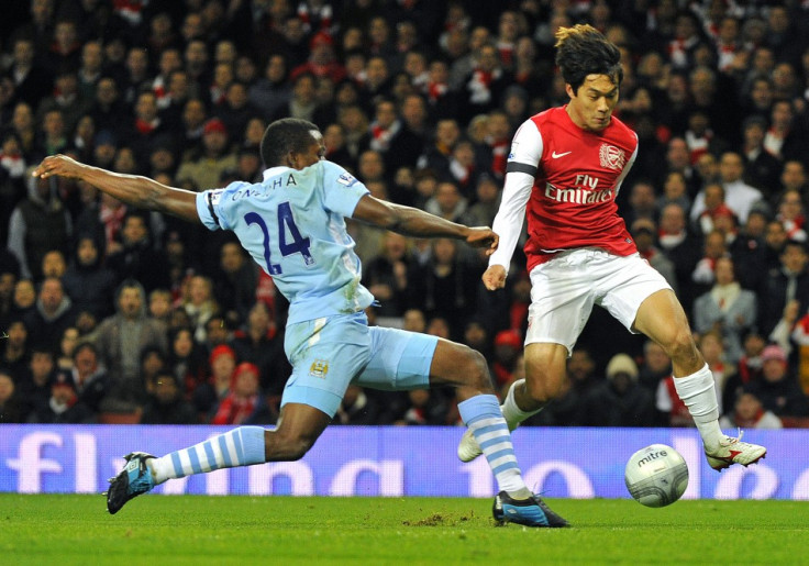 Park of Arsenal evades the challenge of Onuoha of Manchester City during their English League Cup soccer match in London