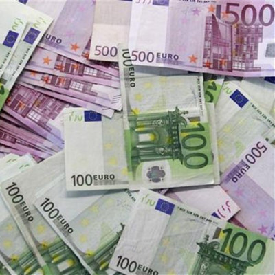 Euro notes are spread out at a bank branch in Madrid