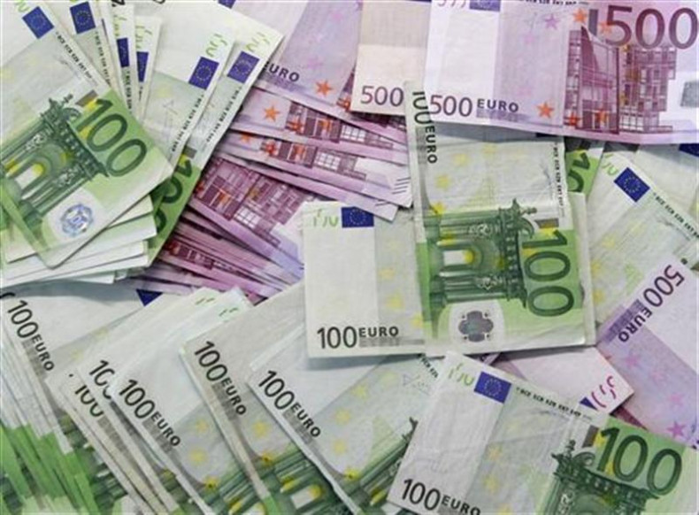Euro notes are spread out at a bank branch in Madrid