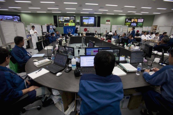 Employees of Tokyo Electric Power Co. (TEPCO) work inside the emergency operation