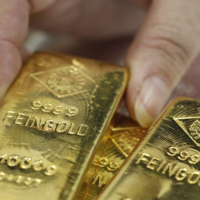 An employee picks up a gold bar at the Austrian Gold and Silver Separating Plant &#039;Oegussa&#039; in Vienna August 26, 2011.