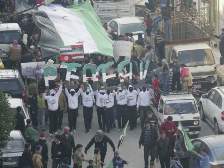 Demonstrators protesting against Syria's President Bashar al-Assad march through the streets after Friday prayers in Adlb