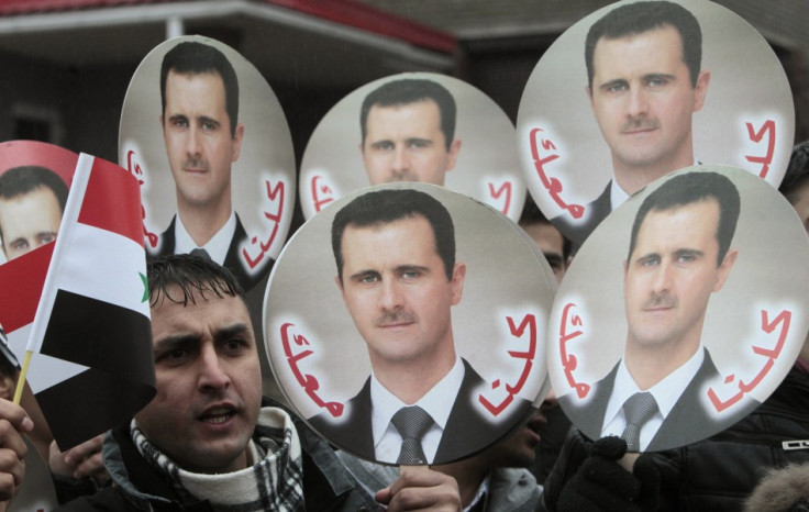 A Syrian citizen takes part in a rally in support of President Bashar al-Assad in front of the Syrian embassy in Minsk