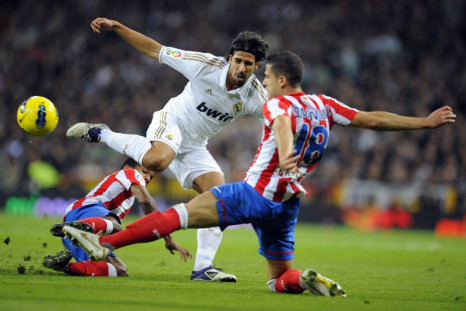 Real Madrid&#039;s Sami Khedira fights for the ball with Atletico Madrid&#039;s Alvaro Dominguez during their first division soccer match at Santiago Bernabeu stadium in Madrid