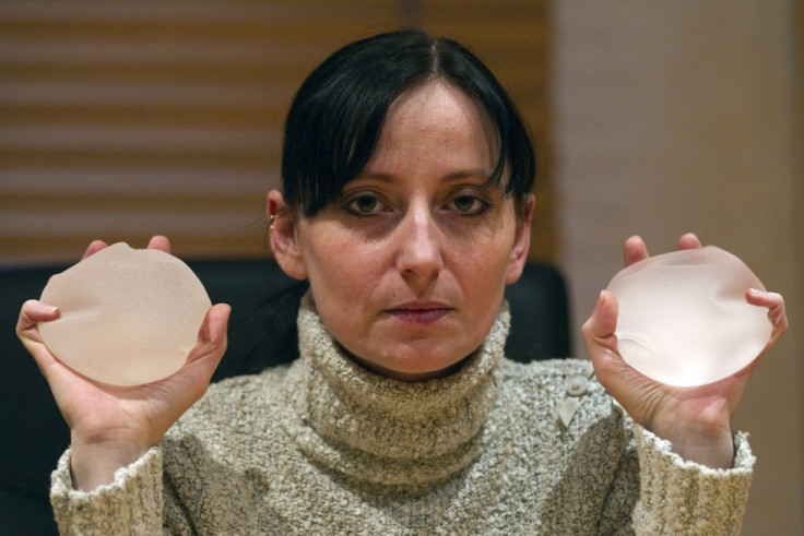 Alexandra Blachere holding breast implants