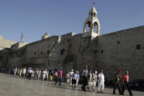 Holy Land tourists file past the Church of the Nativity, in the West Bank town of Bethlehem