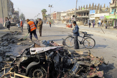 A boy stands near the site of a car bomb attack in Baghdad's Shaab District, northern Baghdad