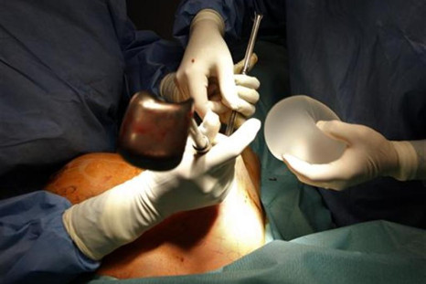 Plastic surgeon Boucq displays a new silicone gel breast implant to replace a defective implant manufactured by French company Poly Implant Prothese after he removed it during a surgery operation in a clinic in Nice