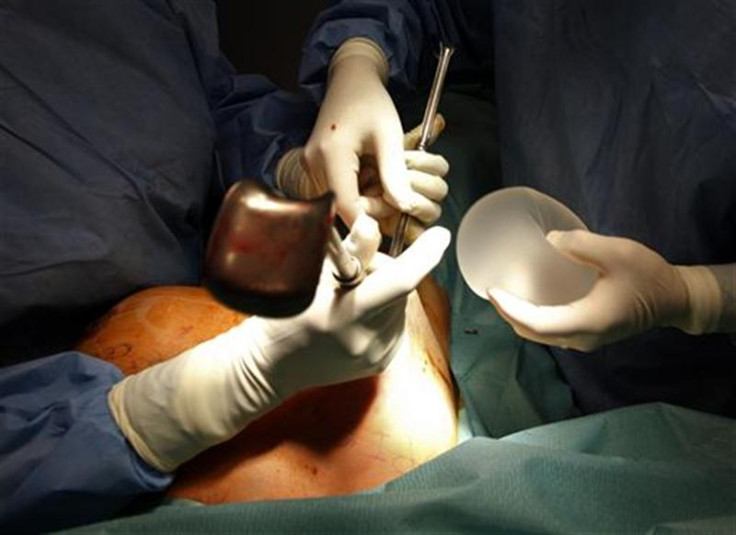 Plastic surgeon Boucq displays a new silicone gel breast implant to replace a defective implant manufactured by French company Poly Implant Prothese after he removed it during a surgery operation in a clinic in Nice