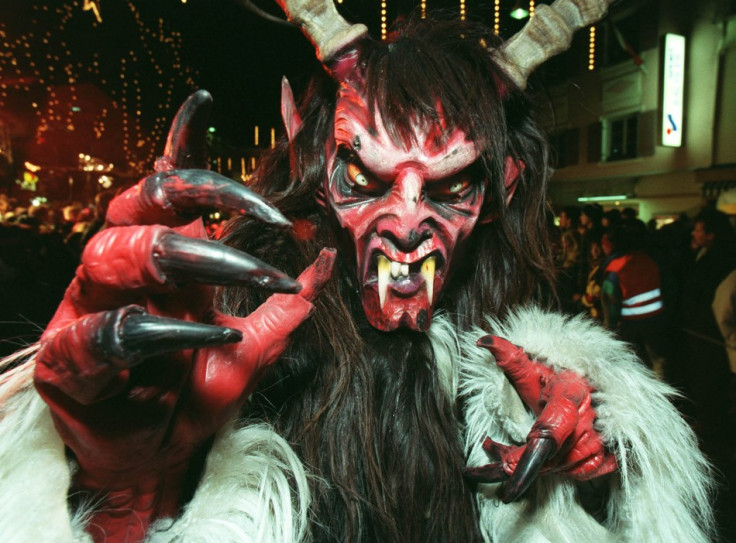 A man dressed in a costume of a Krampus, a traditional devil like figure