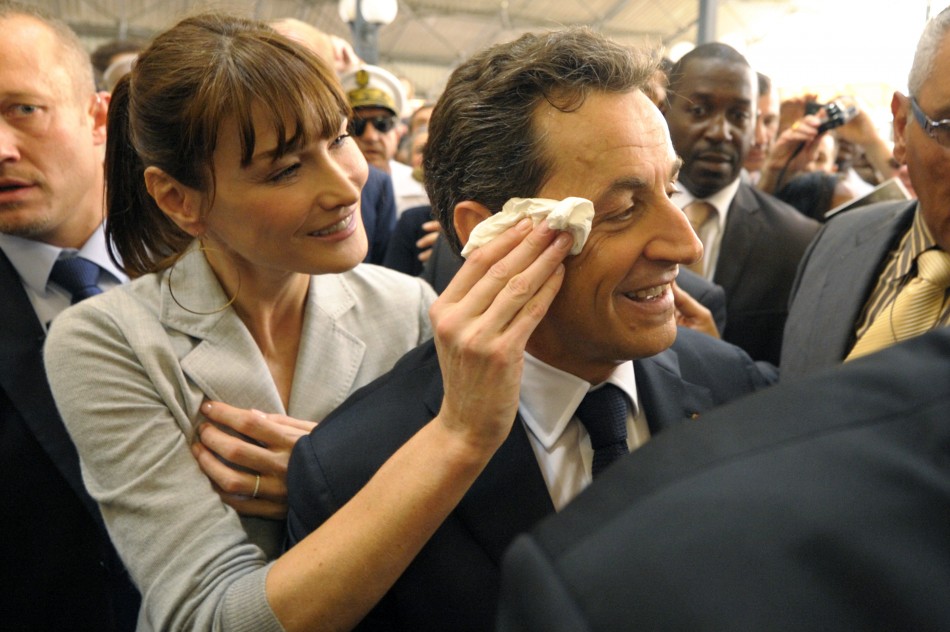 Carla Bruni-Sarkozy wipes the forehead of her husband, Frances President Sarkozy