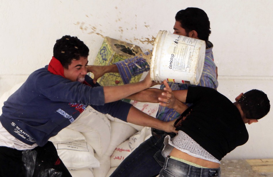 Two Copts scuffle with a man before the clashes between Coptic youths and riot police