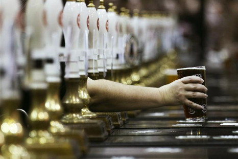 A pint of beer is served through rows of beer pumps at the Campaign For Real Ale Great British Beer Festival at Earls Court in London