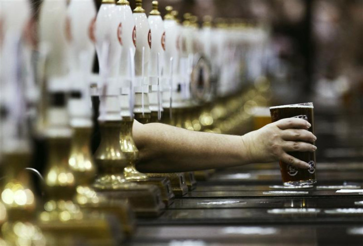 A pint of beer is served through rows of beer pumps at the Campaign For Real Ale Great British Beer Festival at Earls Court in London