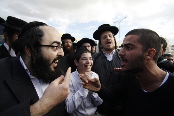 An ultra-Orthodox Jewish man argues with a secular man during a protest