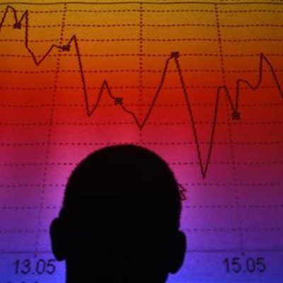 Photo illustration of man silhouetted in board showing Italian equity market index in Rome