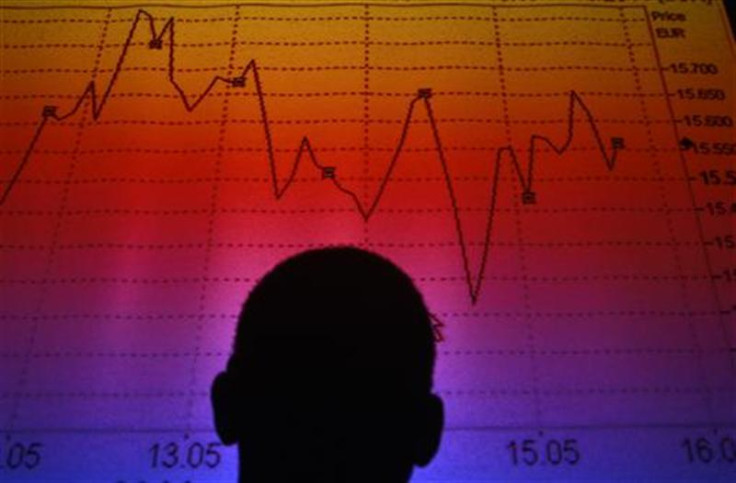 Photo illustration of man silhouetted in board showing Italian equity market index in Rome