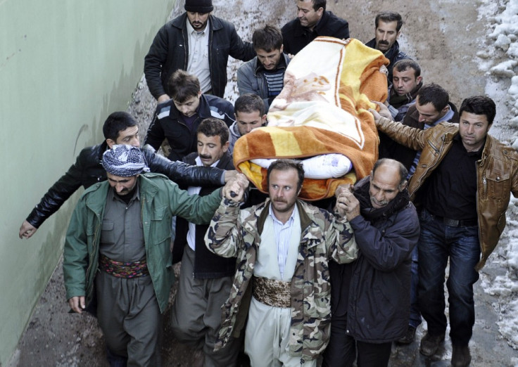 Locals carry a victim, killed in airstrikes, to the morgue of a hospital in Uludere, of the Sirnak province