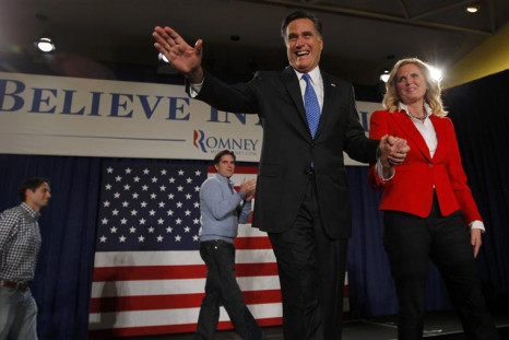 Republican presidential candidate and former Massachusetts Governor Mitt Romney waves to the crowd as he hold his wife Ann's hand at his Iowa Caucus night rally in Des Moines, Iowa