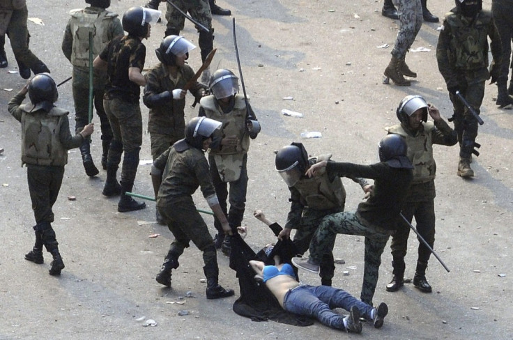 Egyptian army soldiers beat woman protester