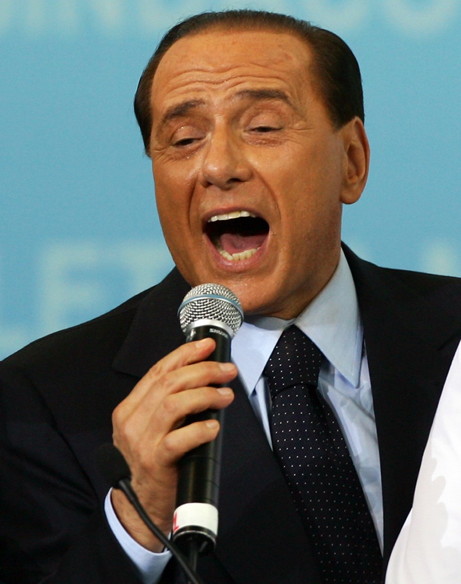 Italys outgoing Prime Minister Berlusconi sings during opening of Letizia Morattis electoral campign in Milan