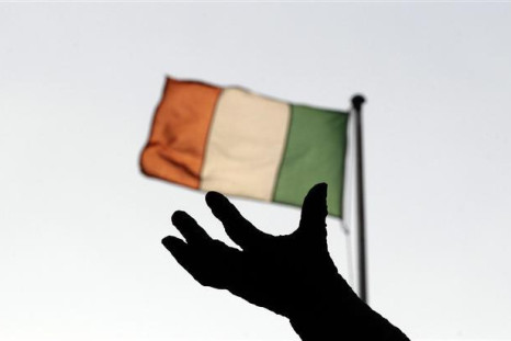 Ireland&#039;s national flag flies above a statue in Dublin