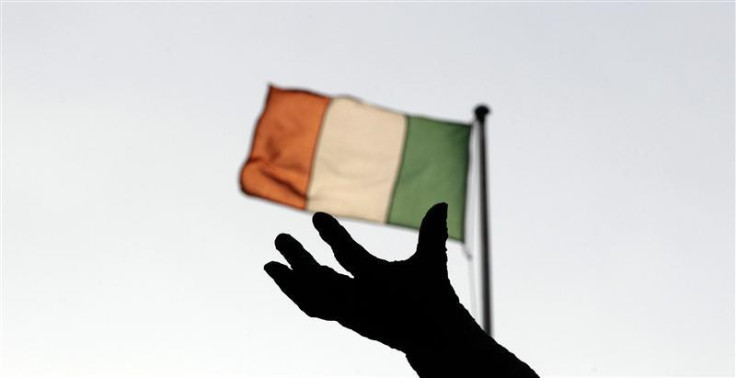 Ireland&#039;s national flag flies above a statue in Dublin