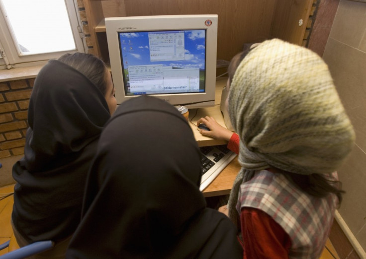 Iranian schoolgirls chat online at an internet cafe