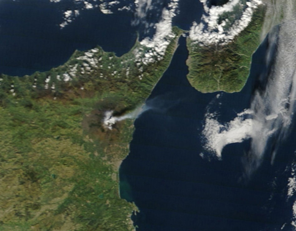 Italys volcanic Mount Etna is seen spewing plumes of ash or steam from this image taken by the Moderate Resolution Imaging Spectroradiometer MODIS on NASAs Terra satellite