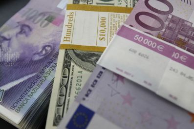 Stacks of Swiss franc, Euro and U.S. dollar banknotes